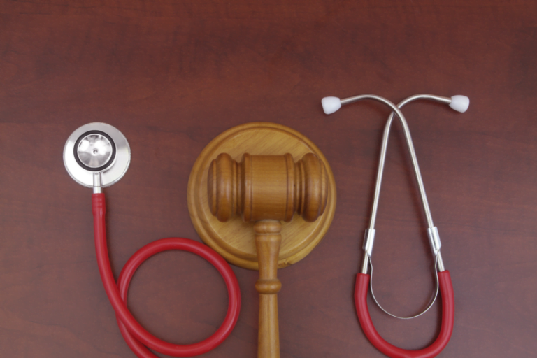 Judge gavel and stethoscope on wooden background ,malpractice concept