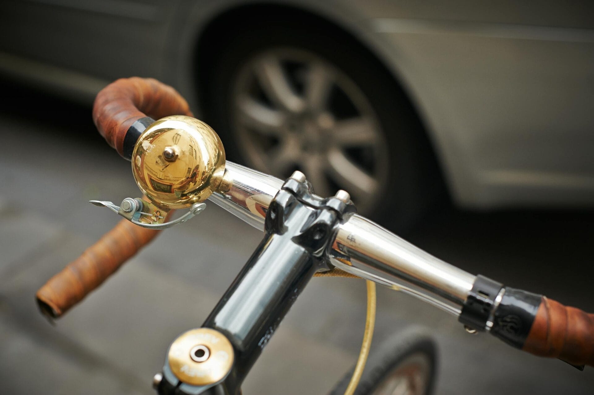 Detailed view of a bicycle bell mounted on handlebars, illustrating urban biking.