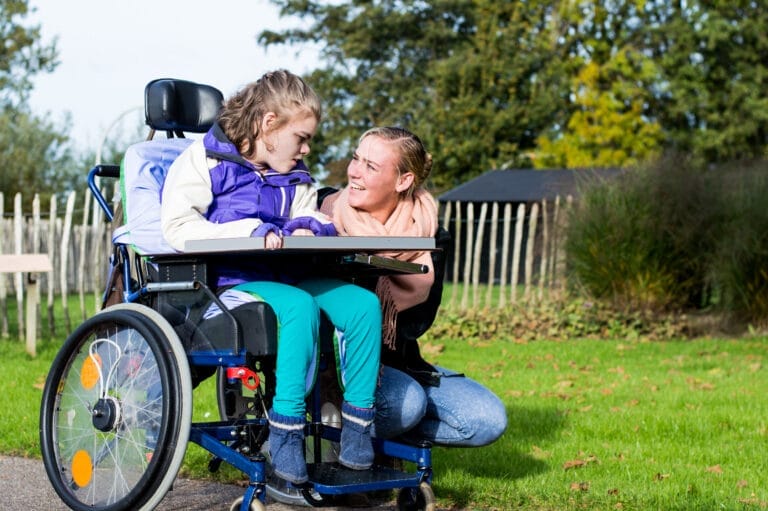 A child, disabled from a birth injury, and her mother at a park in Maryland.