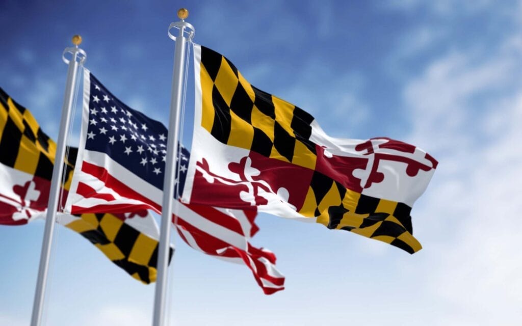 Maryland and American flags waving in the sky.
