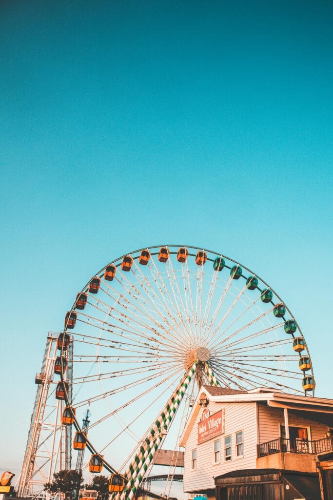 Colorful Ferris wheel at Ocean City's amusement park with a clear blue sky background.