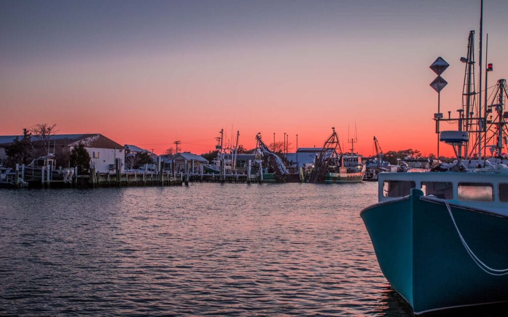 Fishing boats at dock during colorful sunset on the Eastern Shore of Maryland