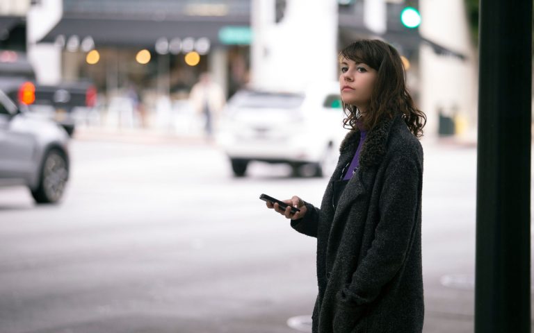 woman waiting for an female driven uber since the company has a history of sexual assault in an uber.